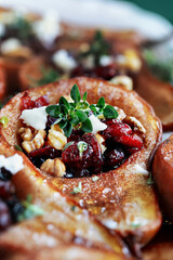 Baked pears. brushed with olive oil and seasoned with some cinnamon. Bake at 375f or 180c degrees for 25 minutes, removed from oven. Add feta cheese, cranberries, walnuts. Garnish with honey and thyme