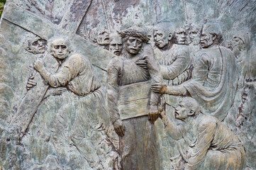 Station V: Simon of Cyrene helps Jesus carry the Cross. The Way of the Cross on Mount Križevac (the Cross Mountain) in Medjugorje.