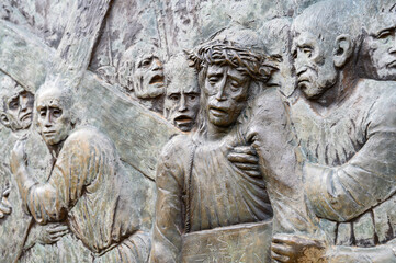 Station V: Simon of Cyrene helps Jesus carry the Cross. The Way of the Cross on Mount Križevac (the Cross Mountain) in Medjugorje.