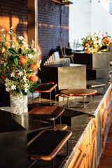 Luxury event bar with floral arrangements and modern serving stands on marble countertop
