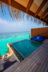 Tranquil closeup calm sea water waves with palm trees. Cabin with pool. Tropical island beach landscape exotic shore coast. Summer vacation, holiday amazing nature. Relax paradise, Maldives.