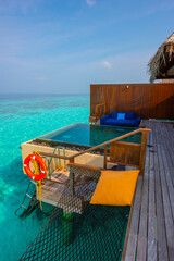 Tranquil closeup calm sea water waves with palm trees. Cabin with pool. Tropical island beach landscape exotic shore coast. Summer vacation, holiday amazing nature. Relax paradise, Maldives.
