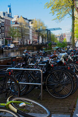 traditional bicycle standing next to canal in Amsterdam, Netherlands
