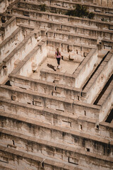 Woman standing in the monumental stone walls of Lithica, Pedreres de s'Hostal, in Menorca, Spain.