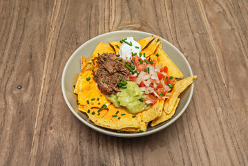 nachos with marinated beef, grilled pineapple, and morita chili salsa