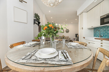 Vintage dining set with a round olive wood table and Thonet chairs, with a romantic bouquet of red roses and baby's breath