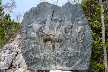 Station III: Jesus falls for the first time. The Way of the Cross on Mount Križevac (the Cross Mountain) in Medjugorje.