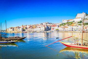 Fototapeta premium Picturesque, colorful view at old town Porto with bridge, Portugal with bridge Ponte Dom Luis over Douro river. Oporto, touristic mediterranean city