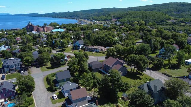 Flyover of a residential area towards a religious convent facing the Restigouche River towards the Bay of Chaleurs between Quebec and New Brunswick, Canada.