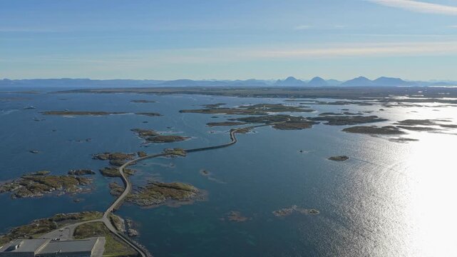 Drone view of car driving scenic road to Veiholmen village, Smola, Norway