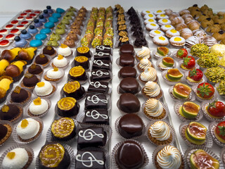 Mix of fruit and cream pastries displayed in a pastry shop. Traditional Italian dessert
