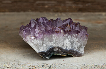 Close-up of a natural amethyst geode showing purple crystals and white quartz base, symbolizing beauty, energy, and mineral perfection