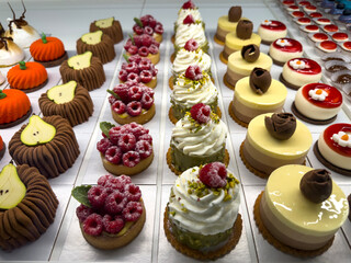 Mix of fruit and cream pastries displayed in a pastry shop. Traditional Italian dessert