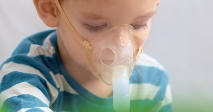Child Using Nebulizer for Breathing Treatment at Home