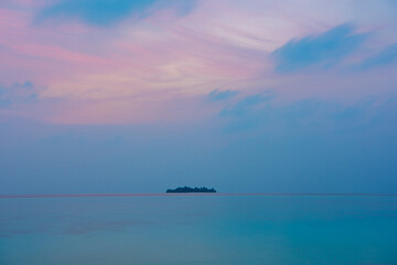 Tranquil closeup calm sea water waves with palm trees. Island at blue hours. Tropical island beach landscape exotic shore coast. Summer vacation, holiday amazing nature. Relax paradise, Maldives.