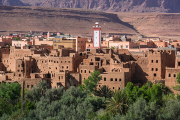 Fototapeta premium Traditional clay kasbahs in the green palm tree oasis in Tinghir town, Atlas mountains, Morocco