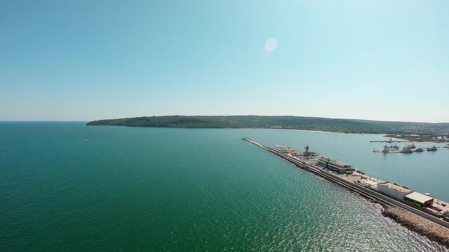 Aerial drone video over Varna Bay showing the breakwater, Marine Station, industrial zone, beach and city with smooth panoramic rotation