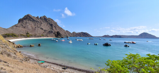 Padar Island, Indonesia - October 17, 2024: Padar Island, view from the top of a beautiful bay with anchored boats, Komodo Island National Park, Labuan Bajo, Flores, Indonesia