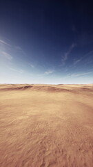 A vast stretch of golden sand unfolds beneath a clear blue sky. Distant hills create a serene backdrop, bathed in warm sunlight during midday, evoking a sense of tranquility.
