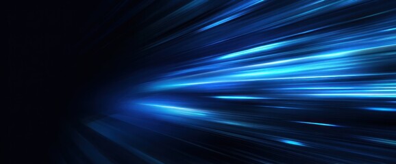 Abstract dark background with bright blue light streaks moving fast.