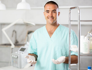 Beside cosmetology chair, physician standing near professional hydrogen oxygen facial machine.