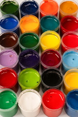 Gouache colorful paints set. Jars of gouache paint isolated on a white background.
