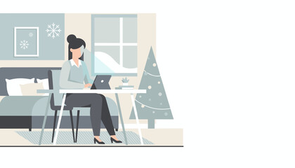 Remote worker using tablet near a Christmas tree in a winter home office setting