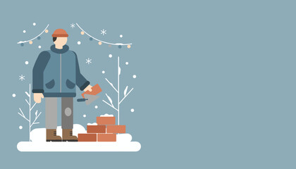 Builder working on masonry construction outside in cold winter weather with snow and holiday lights