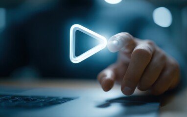 Finger touching glowing digital play button above dark laptop keyboard