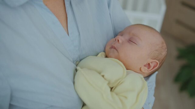 A mother cradles her infant in her arms close up. Concept of late motherhood - Powered by Adobe