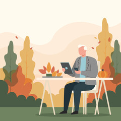 Senior man using tablet and phone outdoors in autumn park Remote work concept