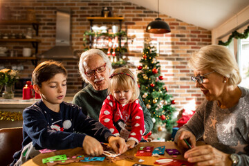 Grandparents and grandchildren crafting at christmas