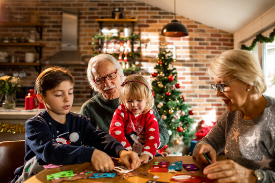 Grandparents and grandchildren crafting at christmas