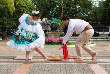 A Latina couple is dancing the traditional Sanjuanero in a plaza in downtown Neiva, Huila, Colombia. Concept of Colombian culture