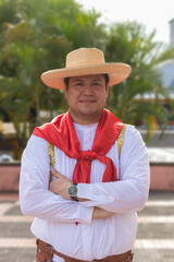 Portrait of a Latin dancer wearing a hat, smiling and looking at the camera in front of an urban convention center in Neiva, Huila, Colombia. Concept of Colombian culture