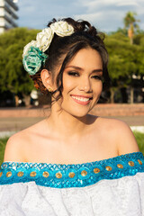 Portrait of a smiling Latina dancer in a traditional dress in Neiva, Huila, Colombia. Concept of Colombian culture and dental health