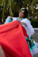 Portrait of a smiling Latina woman in traditional dress dancing the typical Sanjuanero in Neiva, Huila, Colombia. Concept of Colombian culture