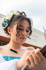 Portrait of a young Latina woman signing a model release with a pen in front of a convention center in Neiva, Huila, Colombia. Concept of Colombian people and education