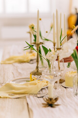 Elegant table setting with white flowers and candles on rustic wood