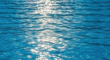 sunlit reflections on a tranquil blue water surface creating shimmering patterns at sea
