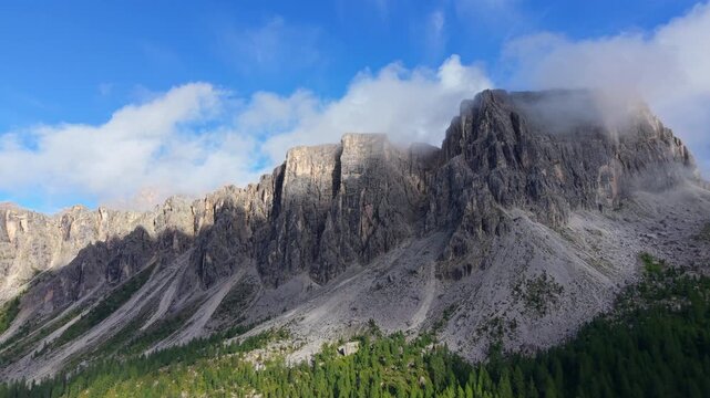 Stunning aerial view of the Croda da Lago mountain range with moving clouds and shadows