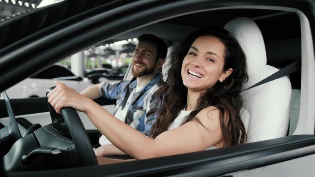 Happy woman going to drive, looking at male instructor in the car. Slow motion