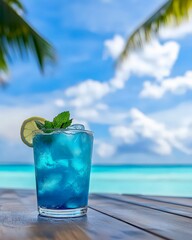 Cool tropical cocktail glass with mint on sunny beach