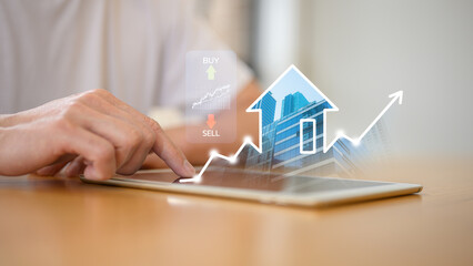Businessman using digital tablet with real estate growth graph property value for real estate investment concept  new home for the family, home search, land price, property tax