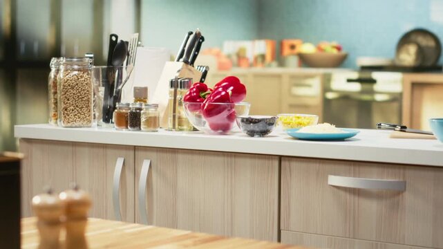 Empty kitchen island arranged with pizza essential such as flour, mozzarella, tomatoes and sauce. Baking tools and utensils line the countertop, reflecting home cooking vibe on the weekend.