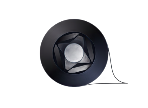 Close up abstract metallic iris diaphragm aperture mechanism with intricate blades and circular opening on black background