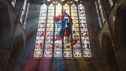 Solitary woman praying in a quiet cathedral pew beneath stained glass, eyes lifted toward sunbeams, seeking comfort and reflection in a sacred space, evening light filtering through arches - Powered by Adobe