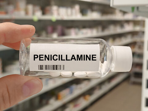Box of PENICILLAMINE tablets on a hospital pharmacy table used to treat Wilson disease and rheumatoid arthritis a chelating agent.