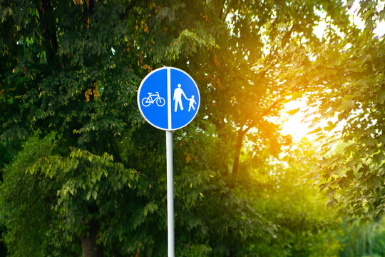Bicycle,pedestrian road sign at city street or park.separated two way direction dedicated walkpath,cycling lane marked route.recreation area track.eco urban commute transportation infrastructure