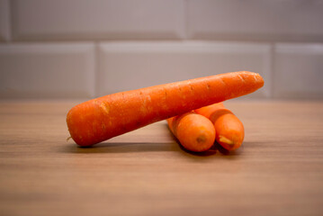 fresh carrots on wooden table